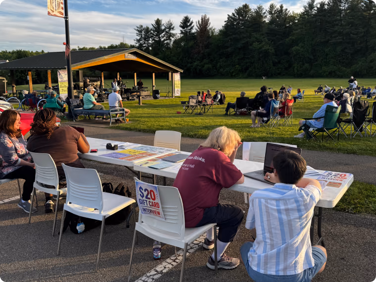 Residents at an outdoor community event in Collier