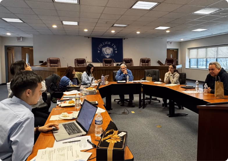 A working session around a conference table in the township building