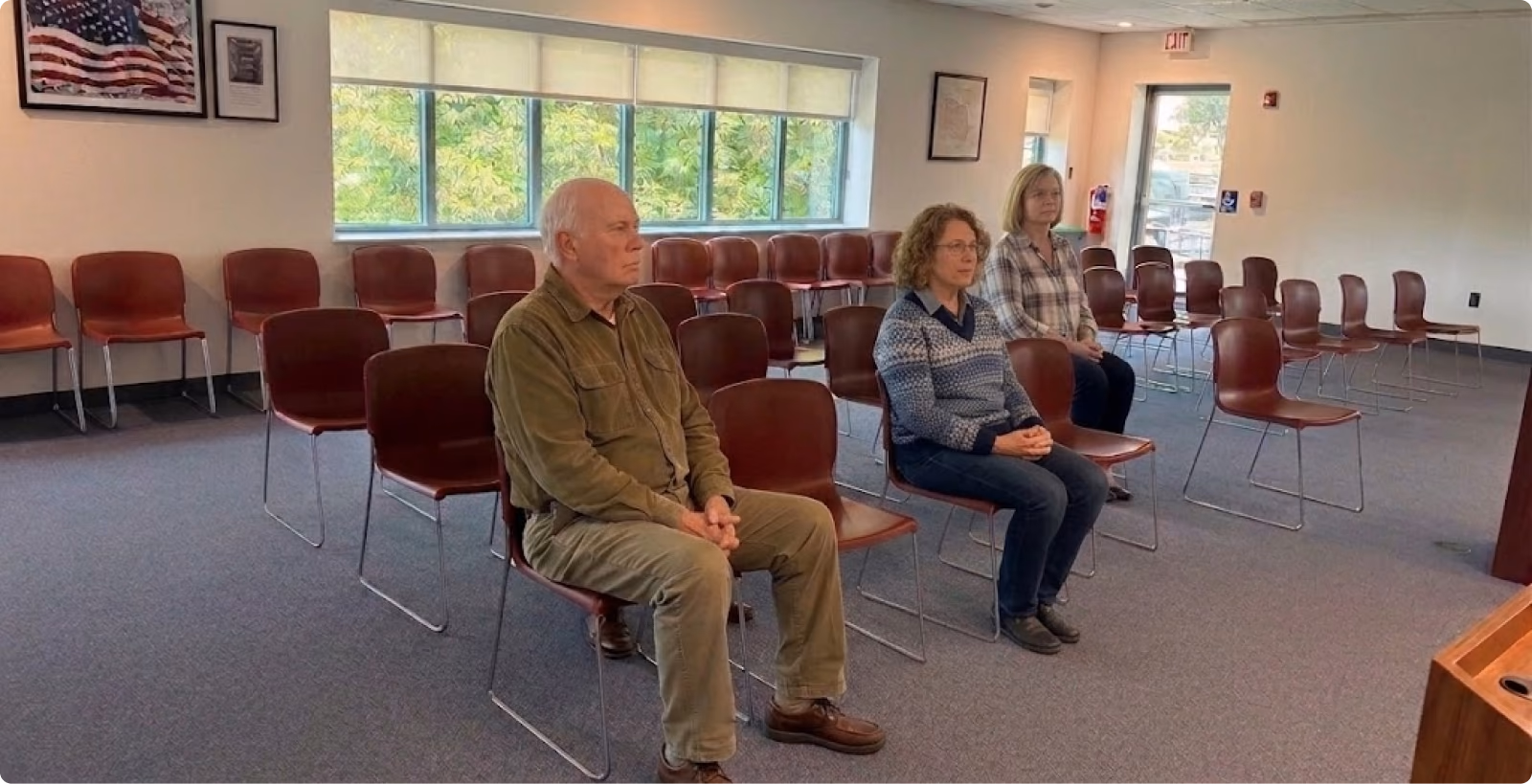 A township meeting room with most of its chairs empty
