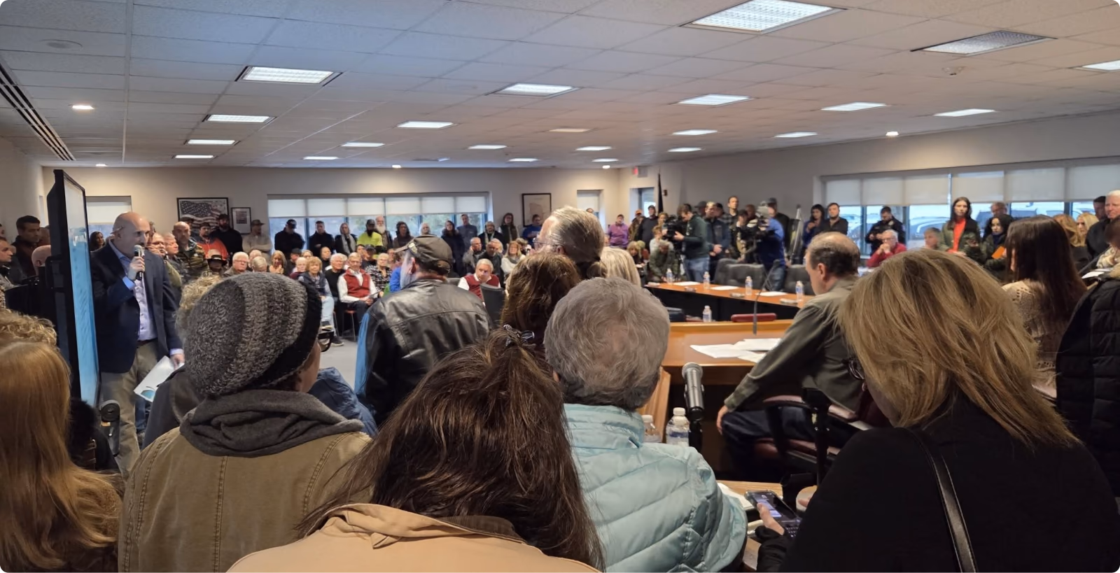 A township meeting room packed with residents